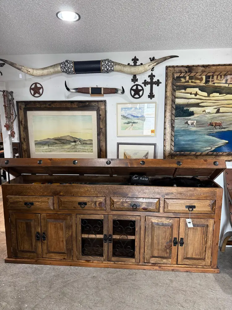 Rustic buffet in Weatherford TX with iron scrollwork doors and western art wall