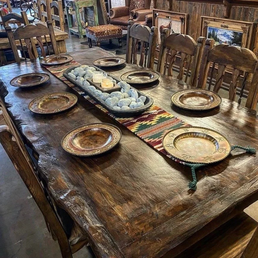 Rustic solid wood dining table with southwestern kilim runner and copper chargers